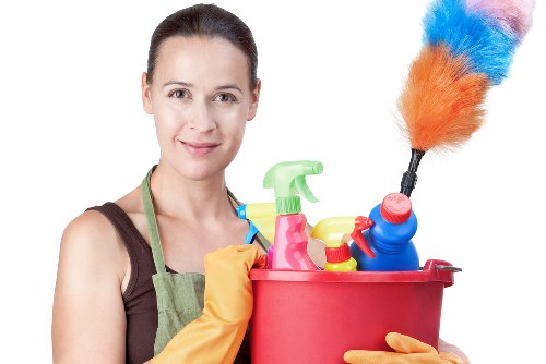 Carpet cleaning professional working safely with equipment in a domestic setting